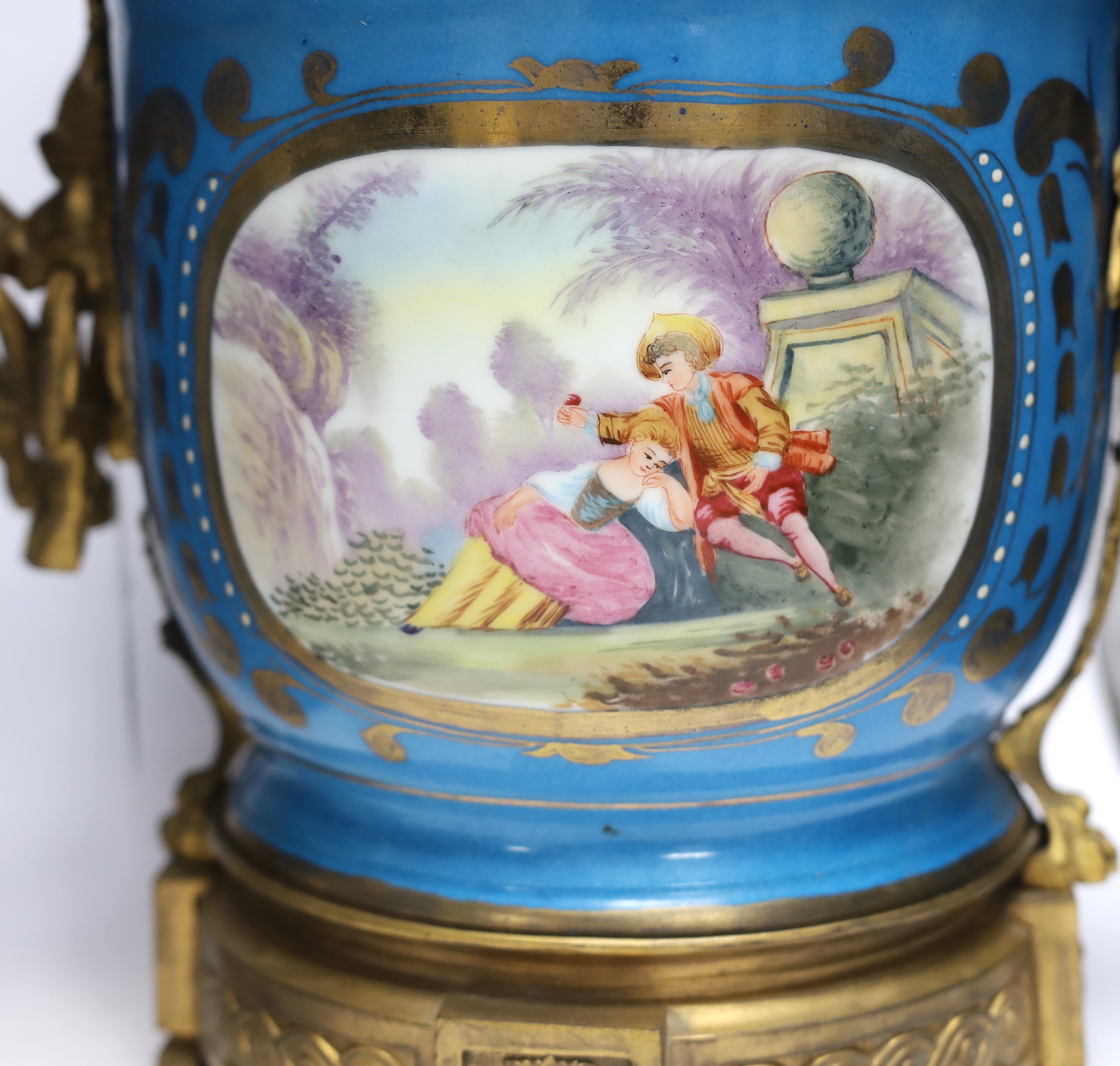 A pair of ormolu mounted Sevres style cache pots, 29cm high